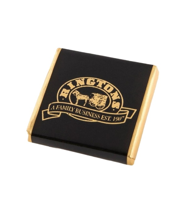 A dark chocolate Whittakers mint wrapped in gold foil and black paper witht he Ringtons logo in gold