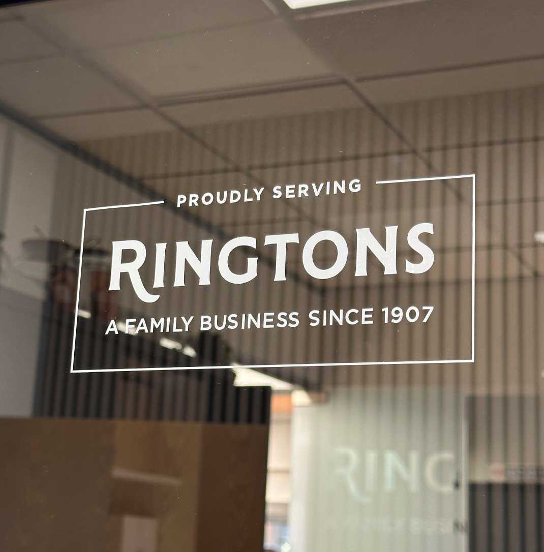 A white Ringtons window sticker saying 'proudly serving Ringtons, a family business since 1907'