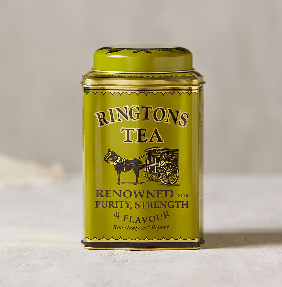A green metal Ringtons tea caddy