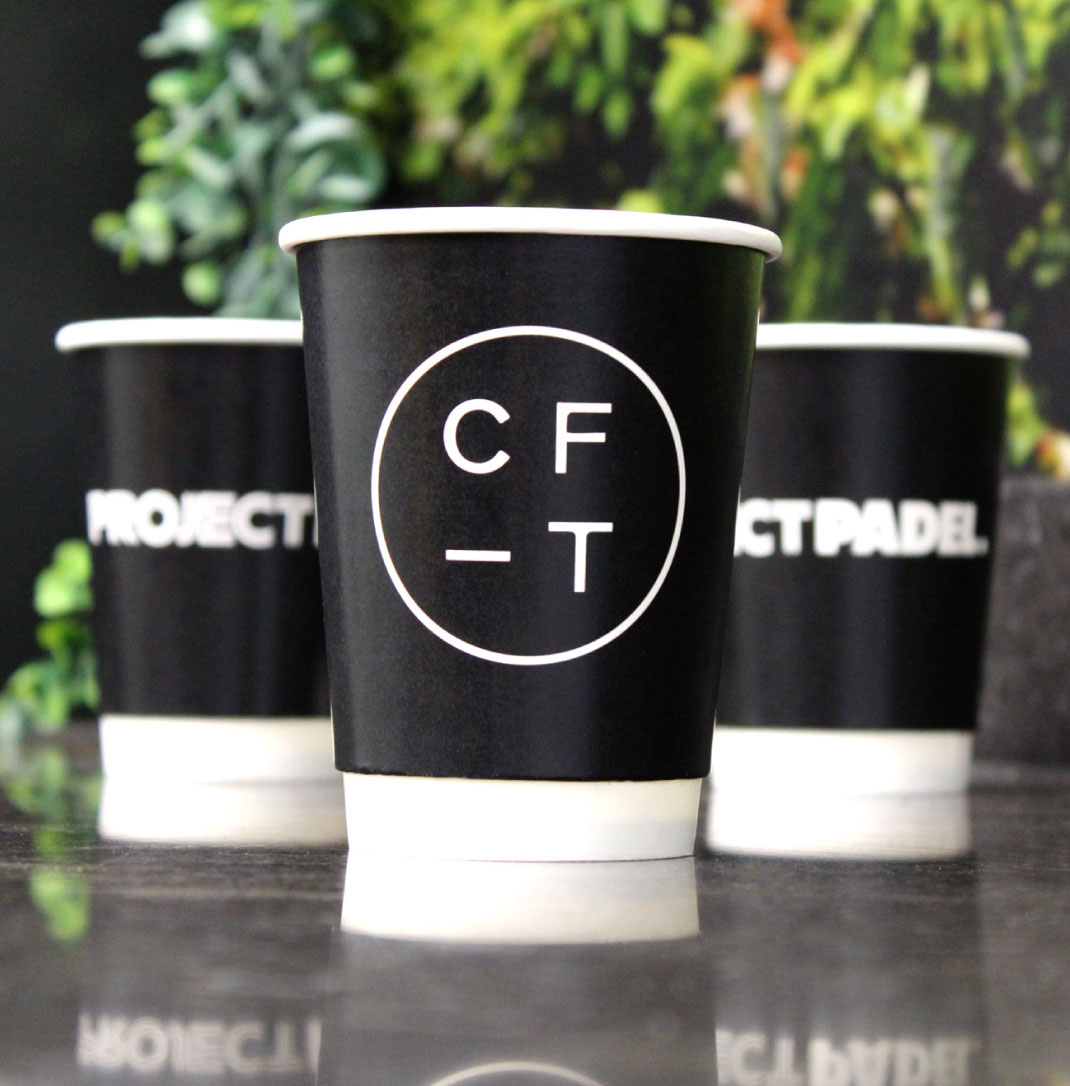 Three bespoke disposable cups with logos on them
